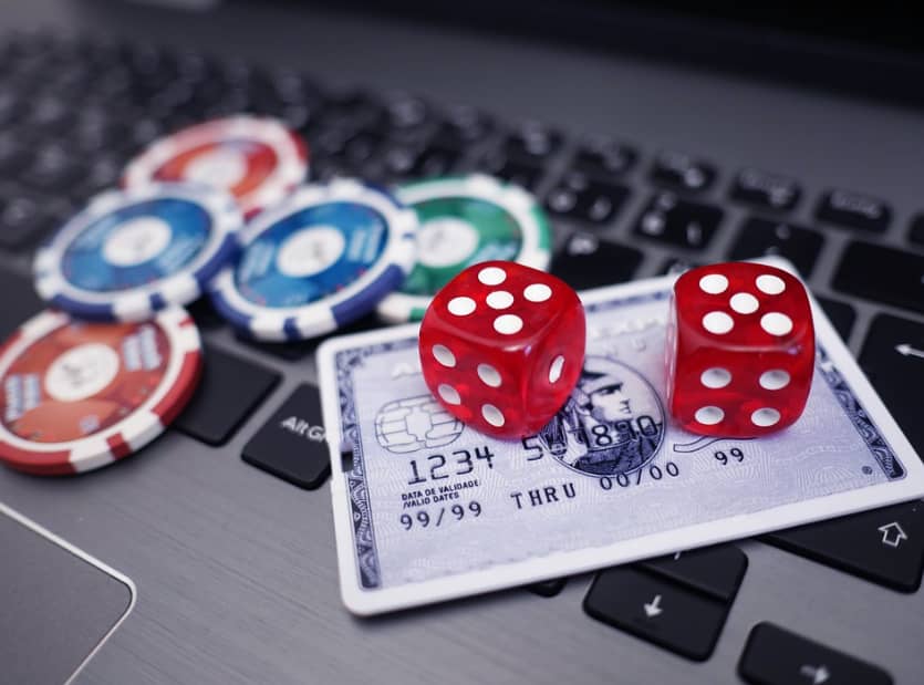 dice and token on top of laptop keyboard for casino